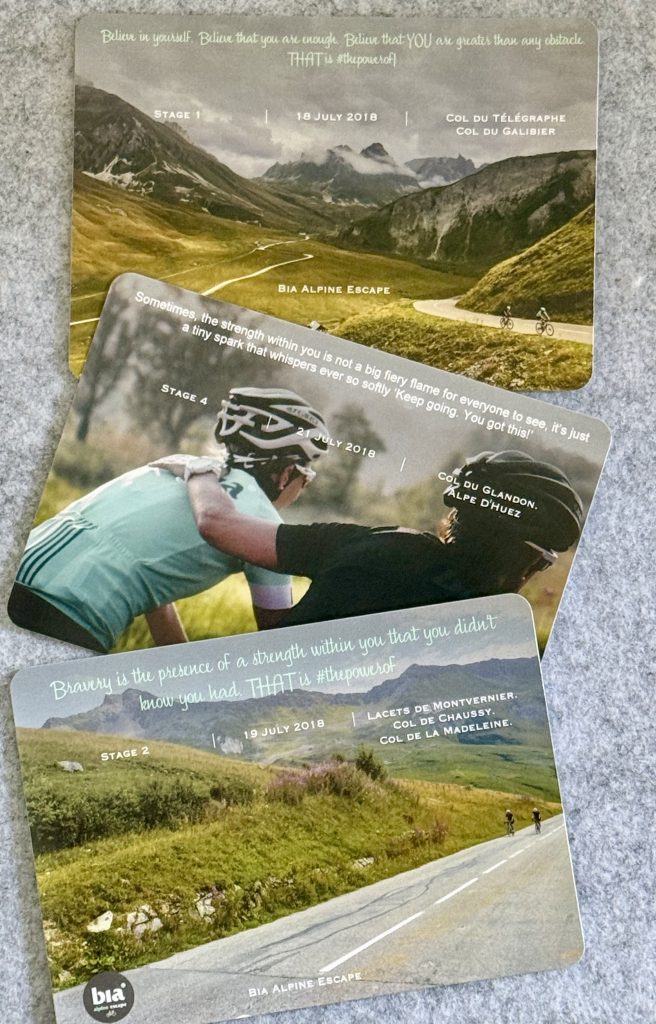 Bia Alpine Escape route cards laid out, each stage's climbs and a motivational quote
