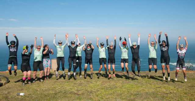 Bia riders jumping for joy on a clifftop above the sea